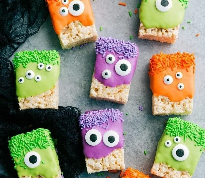 Delicious Halloween desserts displayed on a spooky-themed table.