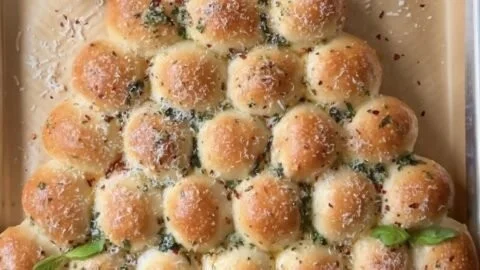 Cheesy Pull-Apart Christmas Tree Bread with melted cheese and festive decorations