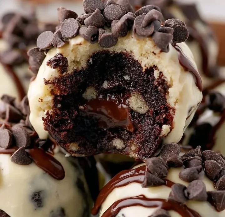 Chocolate Chip Cookie Dough Brownie Bombs topped with melted chocolate