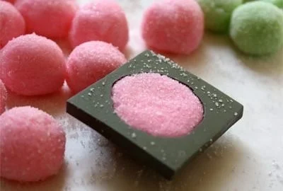 A plate of delicious cream cheese mints in various pastel colors.