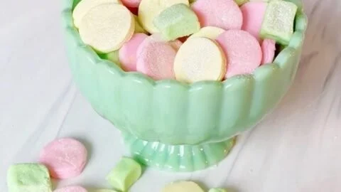 Plate of cream cheese shimmer mints with a colorful shine on top.