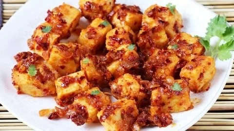 Delicious Garlic Paneer starter dish, garnished with fresh herbs.