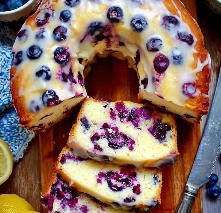 Delicious lemon blueberry pound cake fresh from the oven, topped with blueberries.