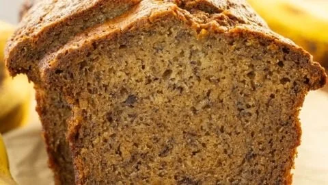 Deliciously moist banana bread sliced and served on a plate.