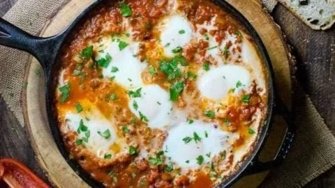 Delicious Pumpkin Shakshuka with baked eggs in a savory tomato stew