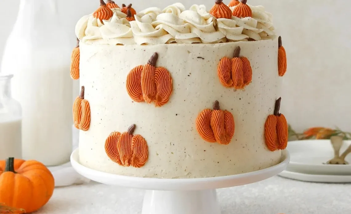 Delicious Vegan Pumpkin Spice Cake topped with spices and frosting.