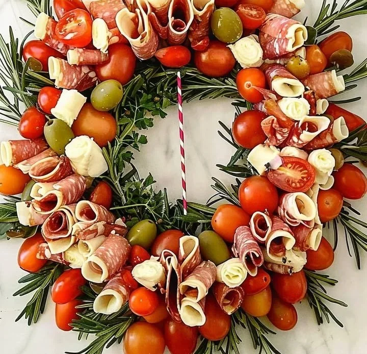 Beautiful antipasto wreath charcuterie board arranged with assorted meats, cheeses, and veggies.