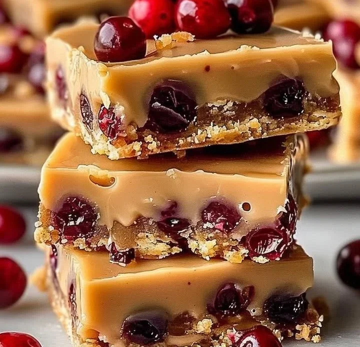 Delicious Cranberry Butterscotch Bars on a plate garnished with cranberries