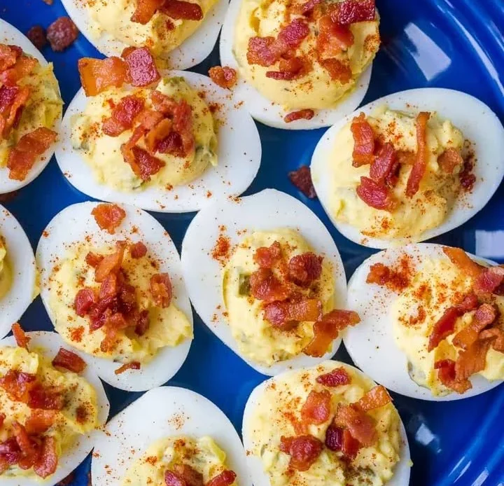 A plate of beautifully garnished deviled eggs ready to serve.