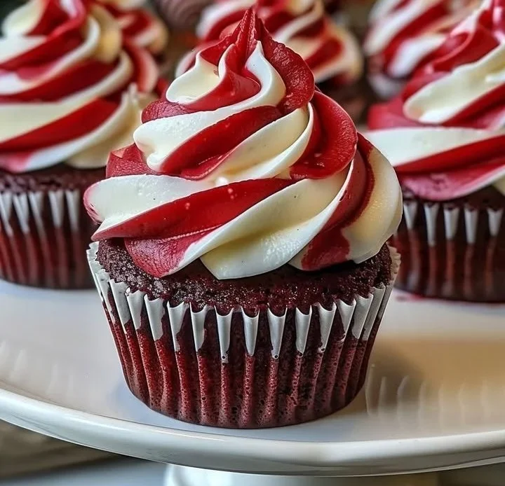 Holiday red velvet cupcakes with cream cheese frosting and festive decorations.