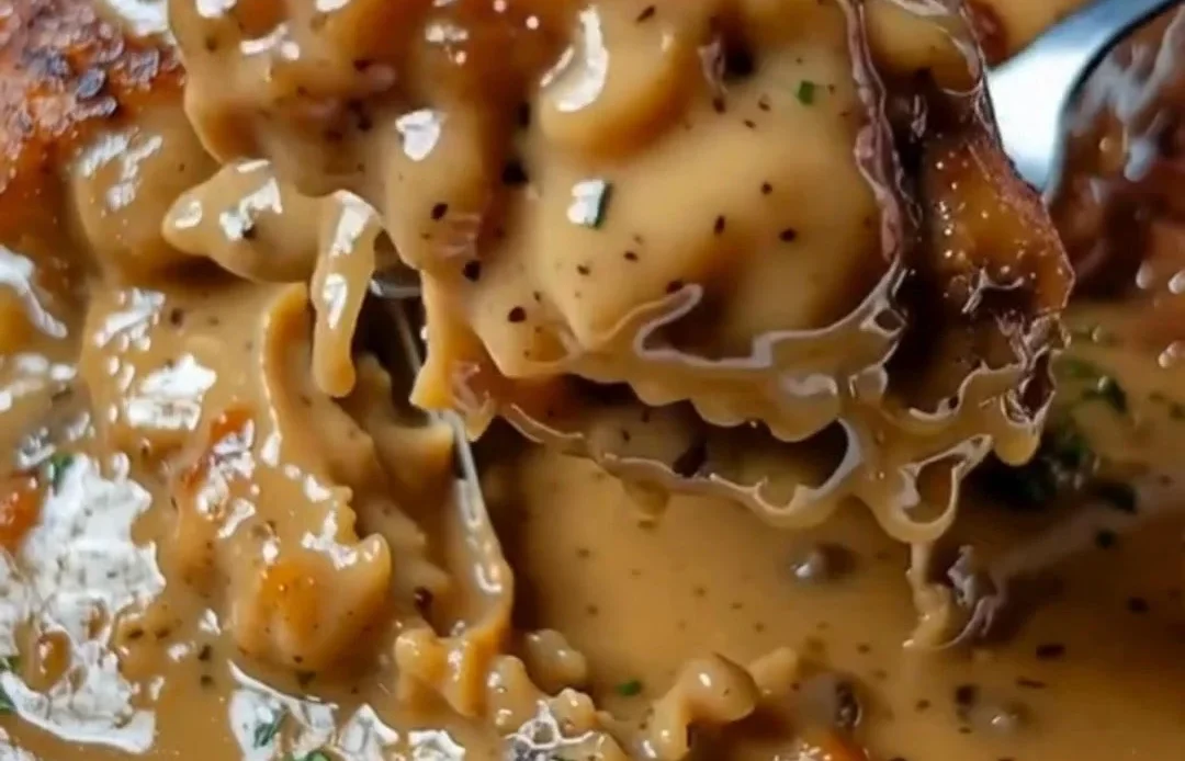 Delicious smothered chicken thighs with rich gravy served on a plate