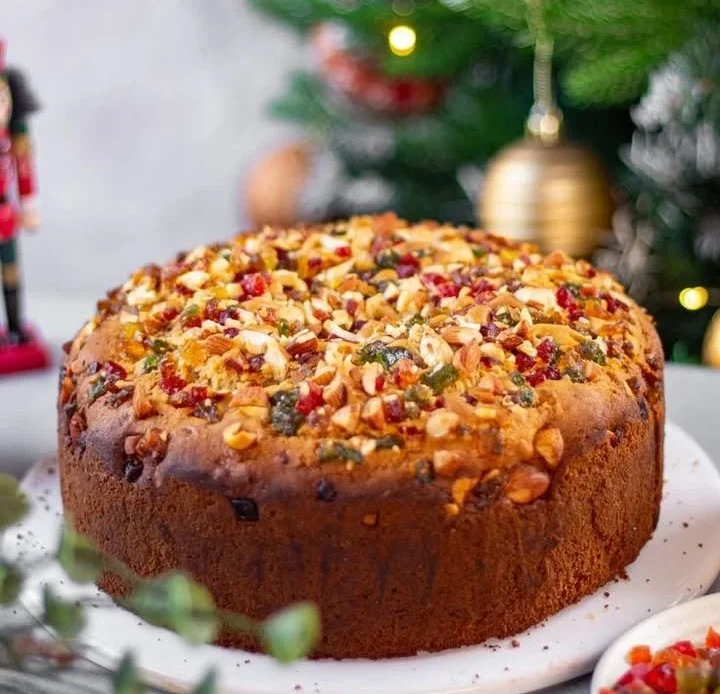 Christmas Eggless Mixed Fruit Cake with colorful fruits and frosting