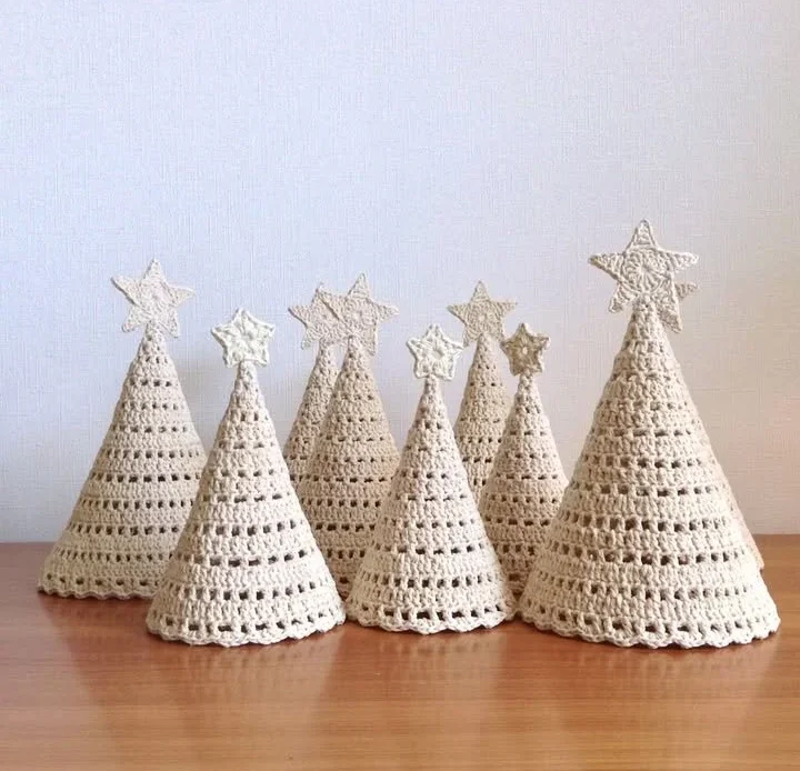 Cream-colored crocheted Christmas trees showcasing a cozy and elegant design.