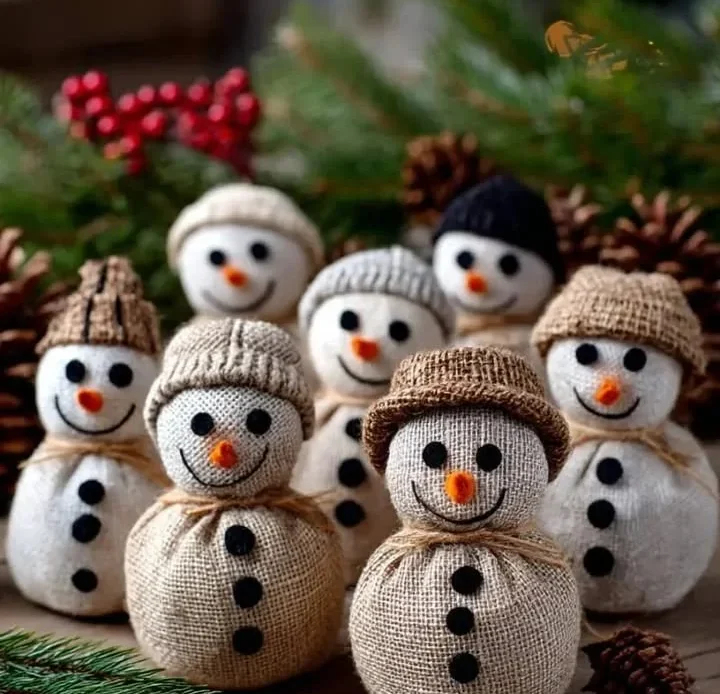 Handmade DIY burlap snowmen adorned with buttons and twine scarves.