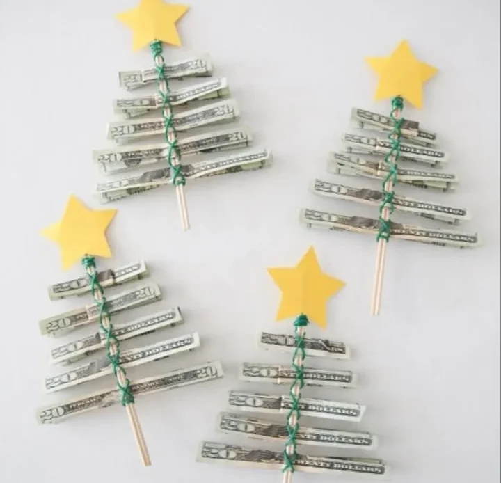 DIY money Christmas tree made from rolled bills and decorative paper stars