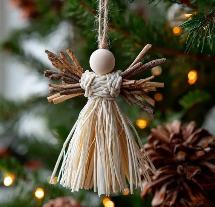 Handmade Christmas tree angel crafted from straw, sticks, and a wooden bead.