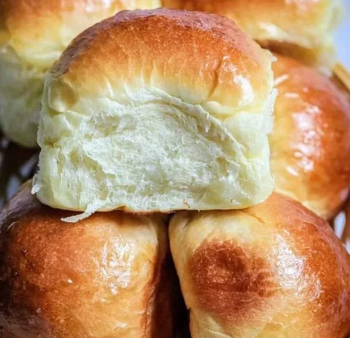 Freshly baked Milk Brioche Rolls on a wooden table