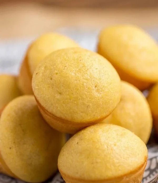 Freshly baked sweet corn muffins on a rustic wooden table